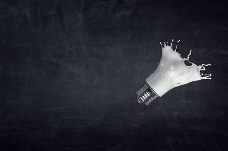 Light bulb with white glass splashの写真素材