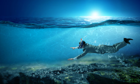 Young businessman in suit swimming