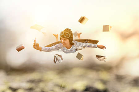 World of books concept with flying boyの写真素材