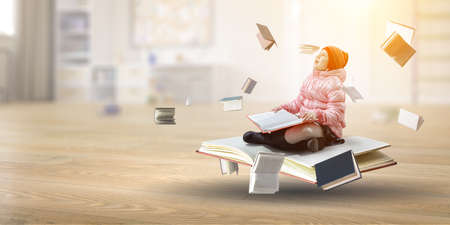 Little girl reading a bookの写真素材