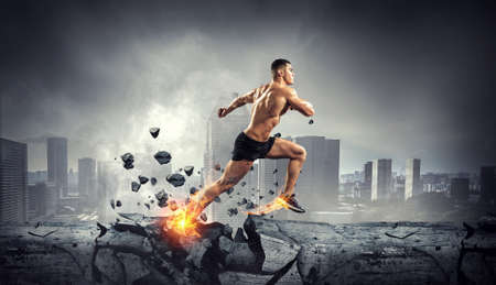 Male runner against cityscape . Mixed mediaの写真素材