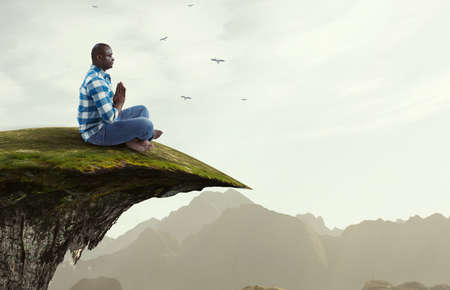 Young black man sitting and meditating