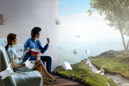 Young couple watching 3D movieの写真素材