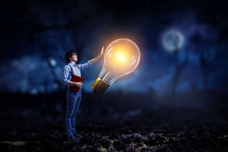 Boy with a glowing light bulb