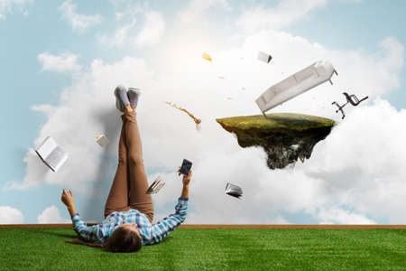 Businessman relaxing with his legs up on wallの写真素材