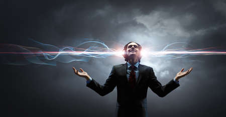 Young businessman with headphones . Mixed mediaの写真素材