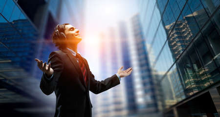 Young businessman with headphones . Mixed mediaの写真素材