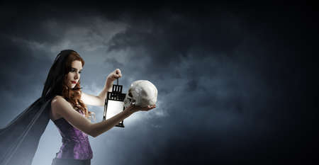 Beautiful young woman in witches hat and costume