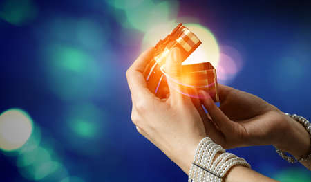 Closeup hands giving surprise gift boxの写真素材