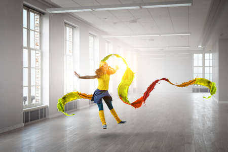Young woman jumping in the airの写真素材
