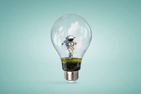 Spaceman inside light bulb . Mixed media