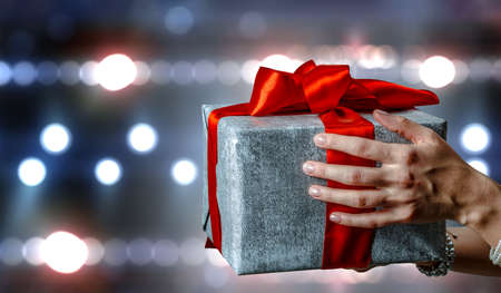 Closeup hands giving surprise gift boxの写真素材