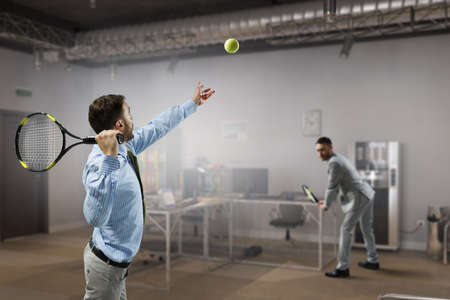 Businessman playing tennis . Mixed mediaの写真素材