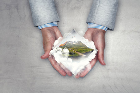 Hands holding mountain . Mixed mediaの写真素材