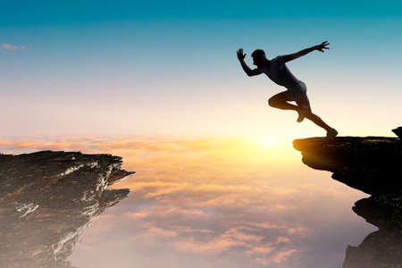 Man running against sunset sky background . Mixed mediaの写真素材