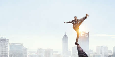Image of businessman balancing on rope. Risk concept . Mixed mediaの写真素材
