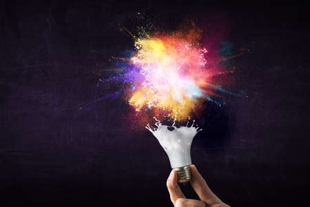 Light bulb with colour paint splash . Mixed mediaの写真素材