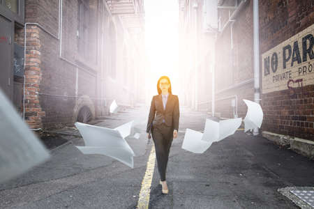Young businesswoman walking towards success . Mixed mediaの写真素材