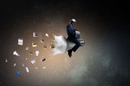 Light bulb with white glass splash with a man on top of it . Mixed mediaの写真素材