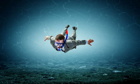 Young businessman in suit swimmingの写真素材
