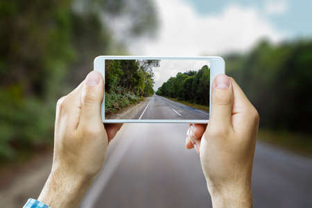 Hand holding smartphone mobile . Mixed mediaの写真素材