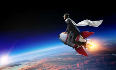 Businessman on a rocket . Mixed mediaの写真素材