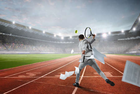 Businessman playing tennis . Mixed mediaの写真素材