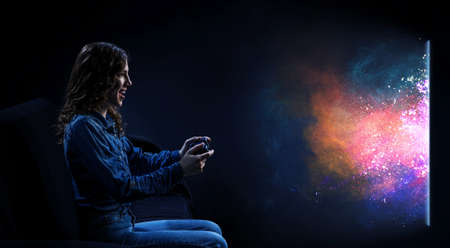 A woman in headphones with a controller set aside in her hands
