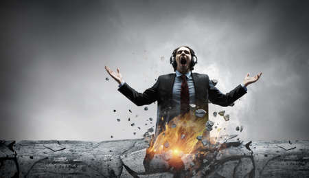 Young businessman with headphones . Mixed mediaの写真素材
