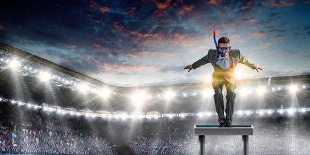 Young businessman in suit ready to dive