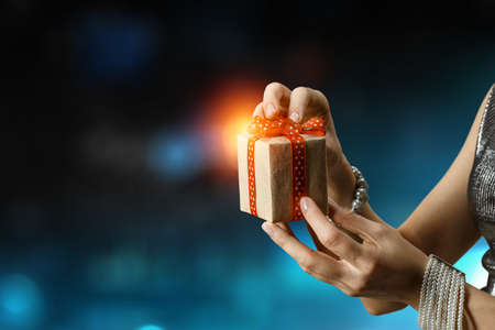 Closeup hands giving surprise gift box