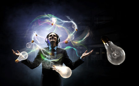 Young businessman with headphones . Mixed mediaの写真素材