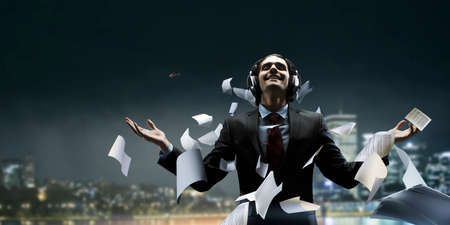 Young businessman with headphones . Mixed mediaの写真素材