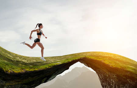 Woman running against natural landscapeの写真素材
