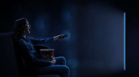 Young woman watching movie . Mixed mediaの写真素材