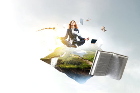 Beautiful businesswoman meditating . Mixed mediaの写真素材