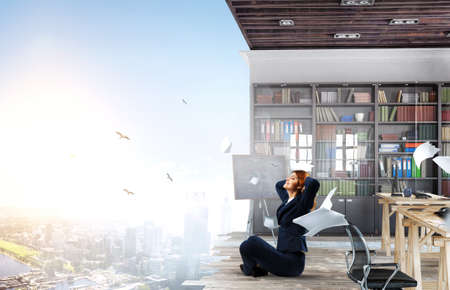 Beautiful businesswoman meditating . Mixed mediaの写真素材