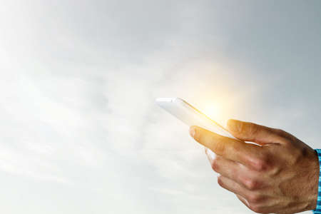 Hand with a smartphone on background