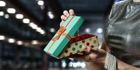 Closeup hands giving surprise gift box