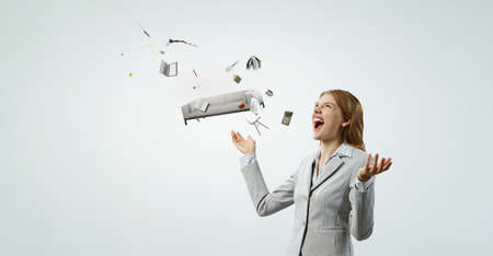 Young pretty businesswoman juggling with business itemsの写真素材