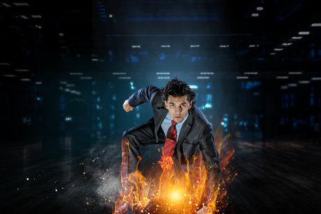 Determined businessman leaving fire trails on asphaltの写真素材