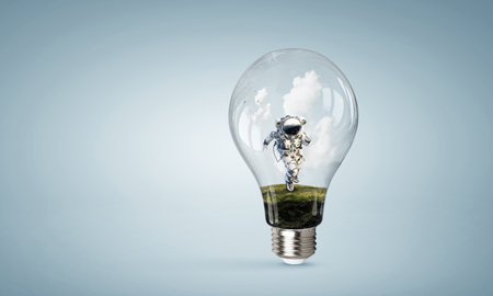 Spaceman inside light bulb . Mixed mediaの写真素材
