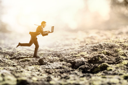 Businessman running among chaos . Mixed mediaの写真素材