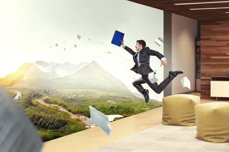 Businessman running among chaos . Mixed mediaの写真素材