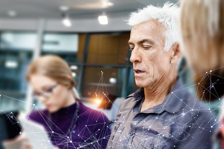 Handsome businessman in office with his colleguesの写真素材