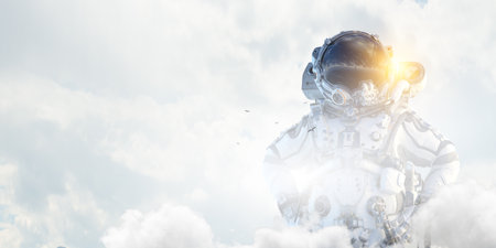 Astronaut against cloudy sky backgroundの写真素材