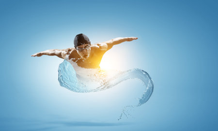 Professional man swimmer on a waveの写真素材