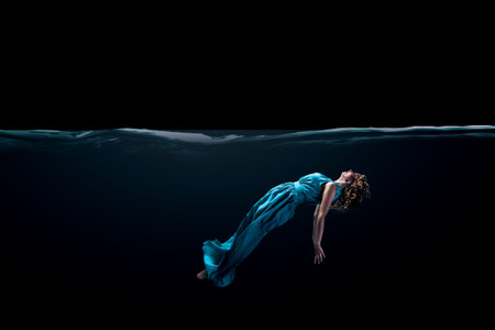 Girl in green dress under water