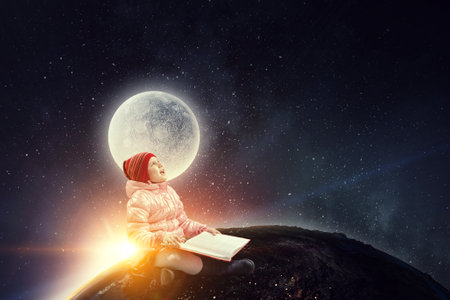 Little girl reading a bookの写真素材