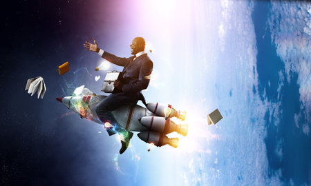 Businessman on a rocket . Mixed mediaの写真素材